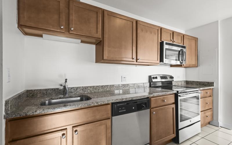 a kitchen with wooden cabinets